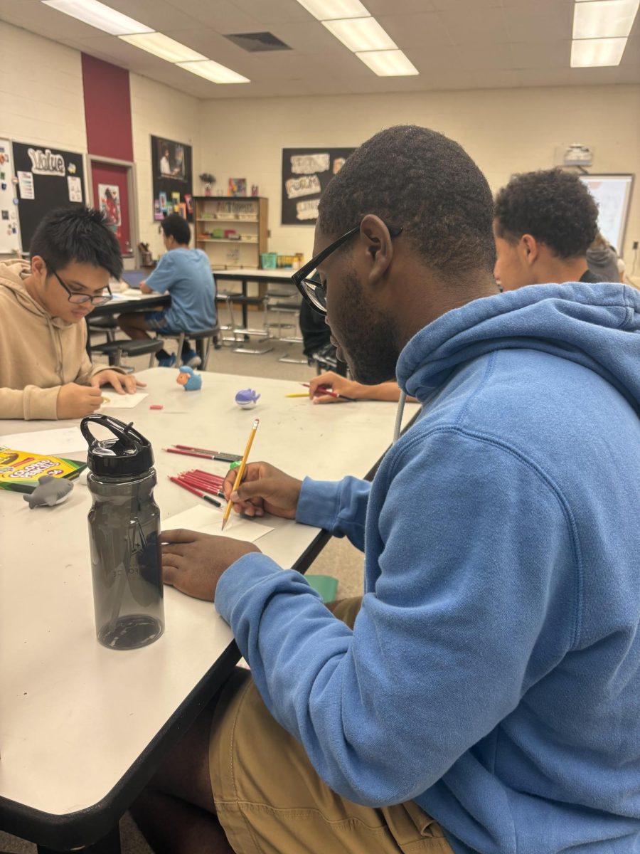 Senior David Brown Jr. working on his still life drawing. 