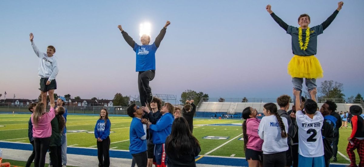 Flyers Karter Hayden, Matthew Billings, and Nathan Fortuna in the air together.