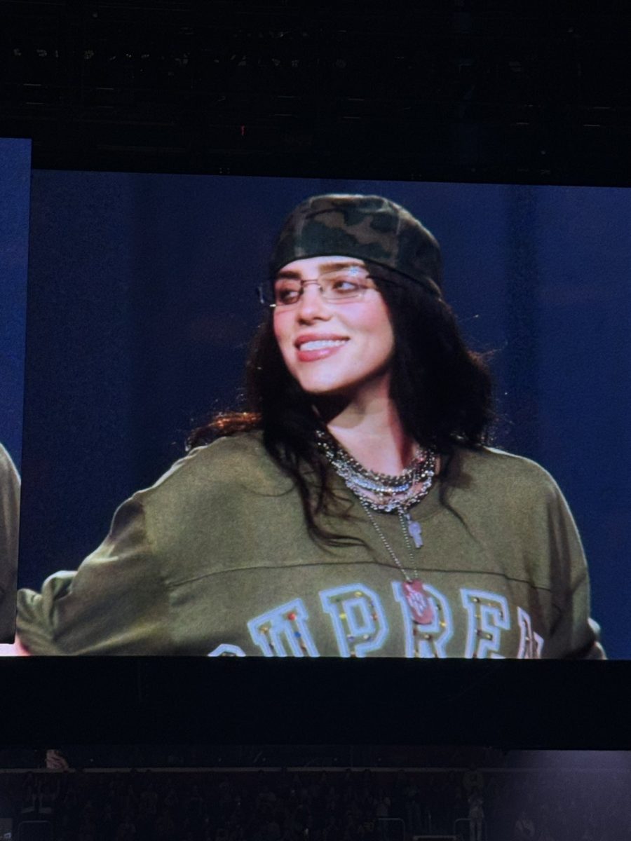 Picture of Billie Eilish on the big screen at her most recent tour titled "The Hit Me Hard And Soft Tour"