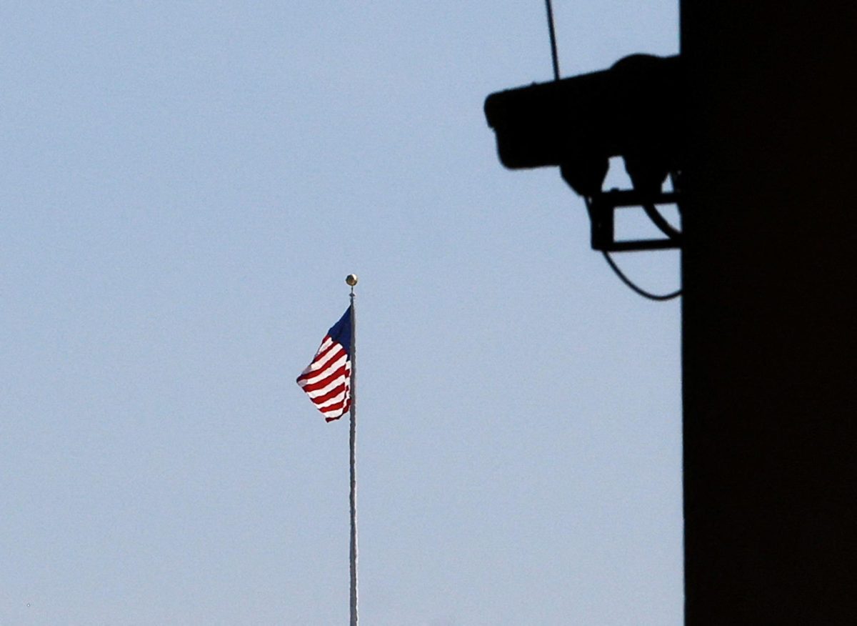 An American flag is seen near a security camera from the E. Barrett Prettyman Federal Courthouse in Washington, U.S., September 5, 2023. REUTERS/Julia Nikhinson