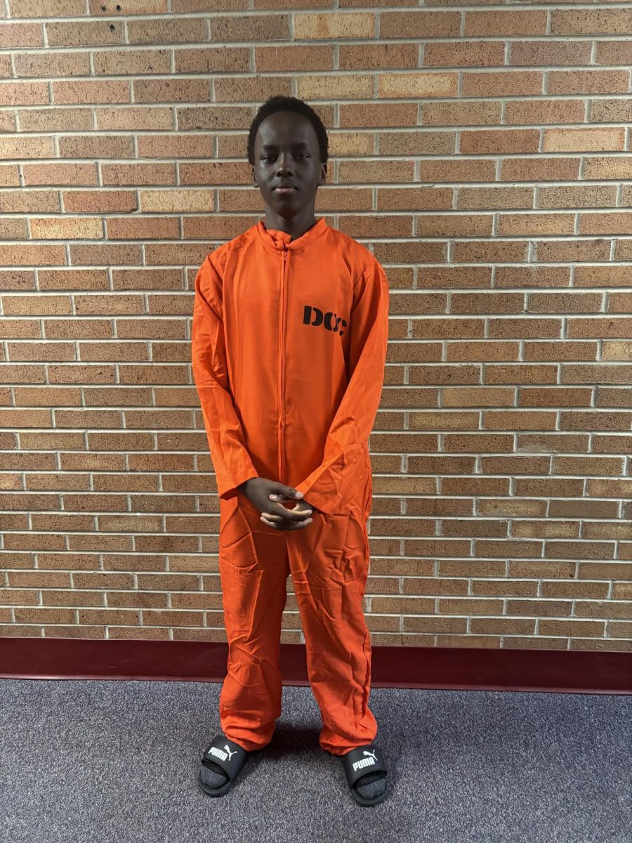 Picture of Victor Kamau dressed as a prisoner