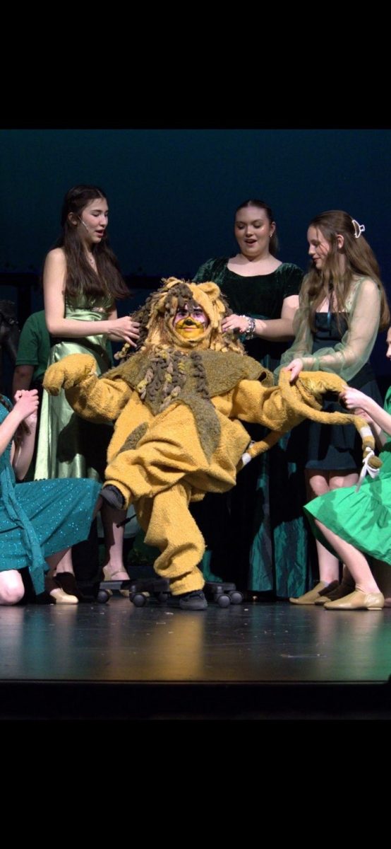 Bri Poe being pampered as the Lion in The Wizard of Oz 