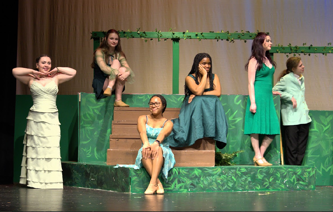 Amari and cast sitting on stage in preperation for "Merry Old Land of Oz",